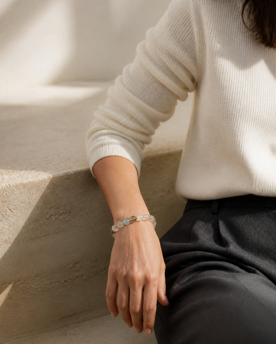 Clear, pale blue and smoky crystal bracelet worn on a wrist