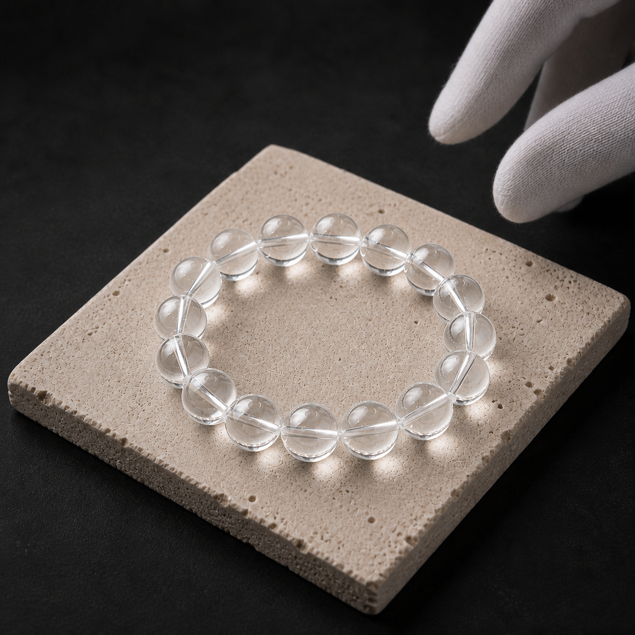 12 mm clear quartz bracelet displayed on a pale stone surface
