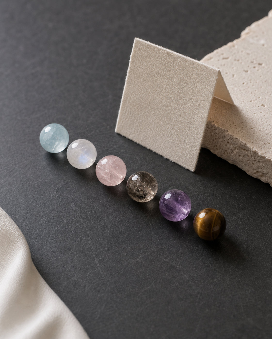 Natural crystal beads arranged to compare colour depth and variation